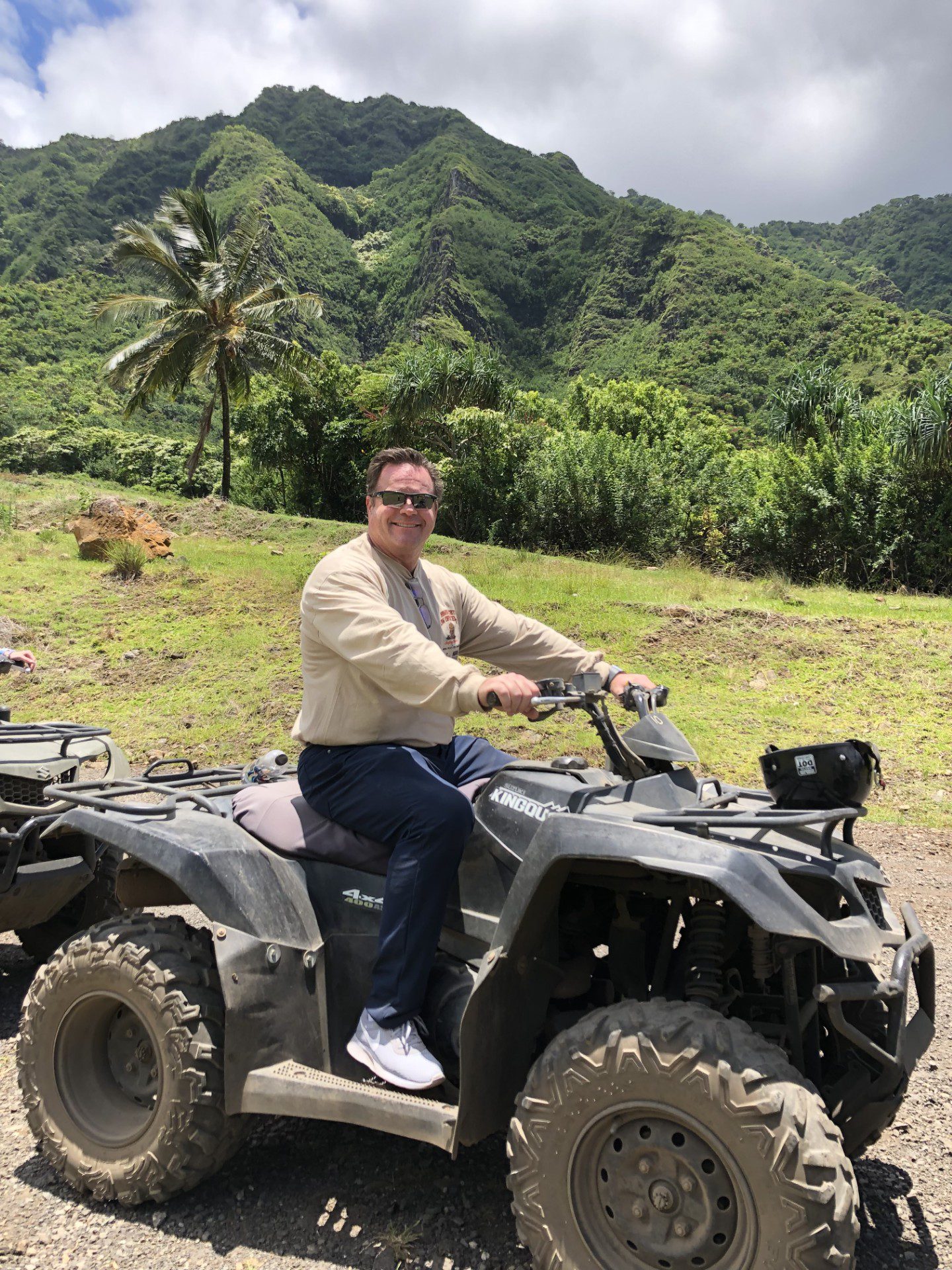 a man posing for a photo while sitting on an ATV