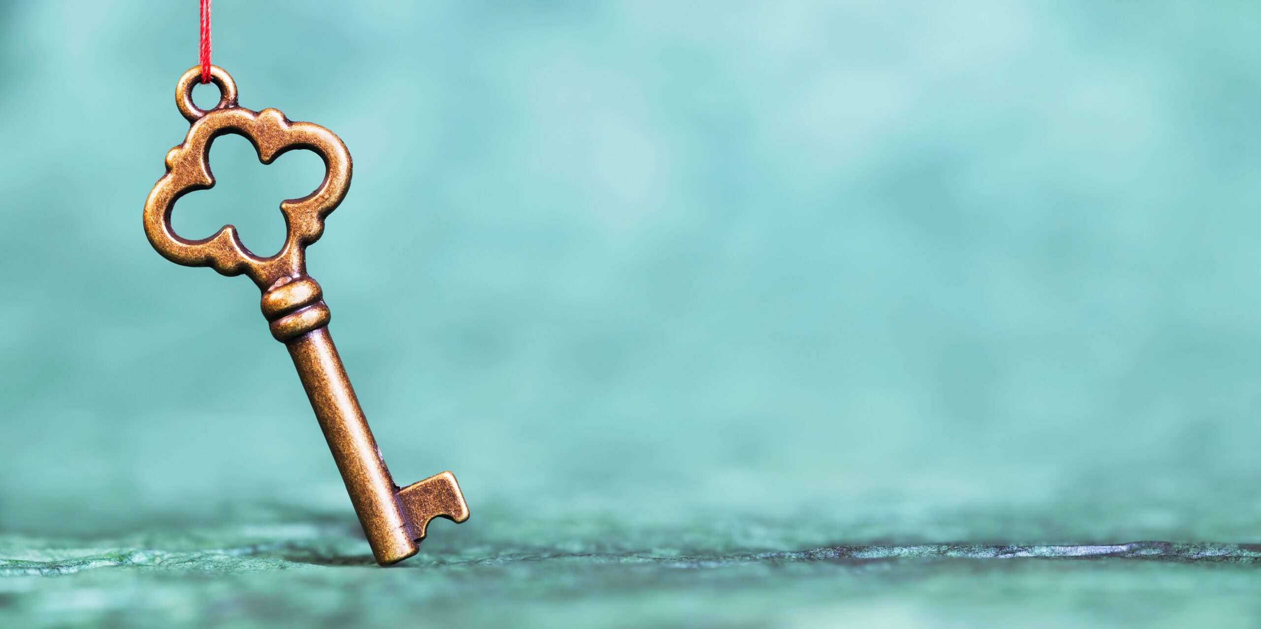 a brass key against a blue background